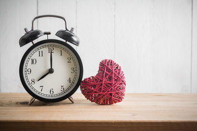 Close-up of clock on table at home