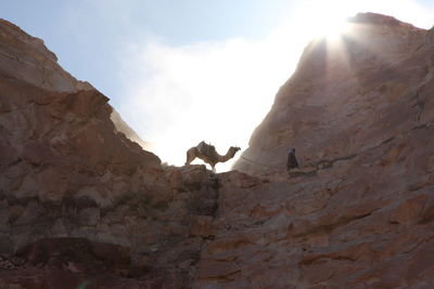 Low angle view of rock formations on mountain against sky