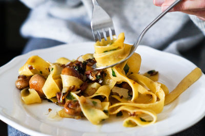 Close-up of person preparing food in plate