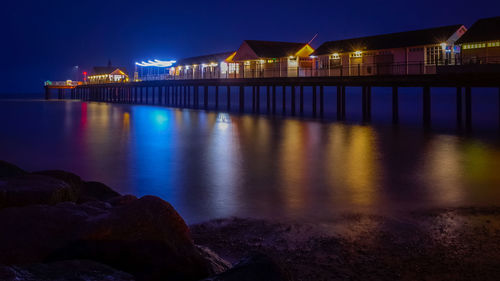 View of bridge over river at night