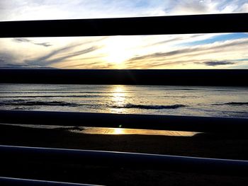 Close-up of silhouette beach against sky during sunset