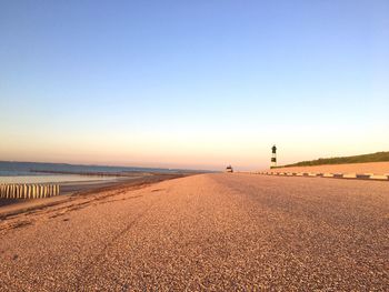 Scenic view of beach against clear blue sky