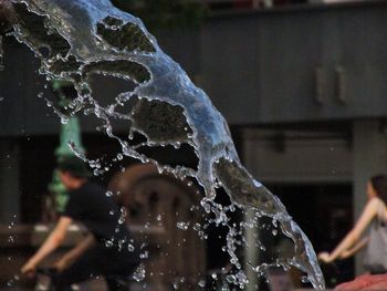 Close-up of woman splashing water