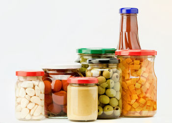 Close-up of drink in jar against white background