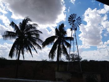 Low angle view of silhouette palm trees against sky