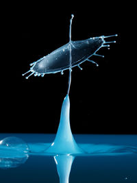 Close-up of water splashing over black background