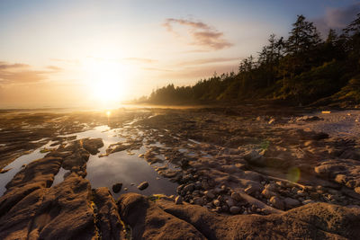 Scenic view of rocks against sky during sunset