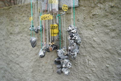 Lucky charm baltic sea hag stone necklaces hanging on a street display for sale with honesty box