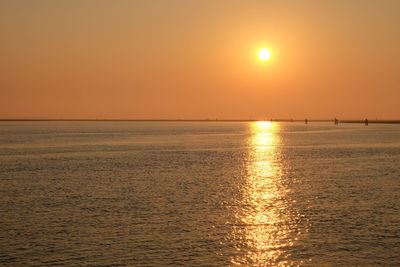 Scenic view of sea against orange sky