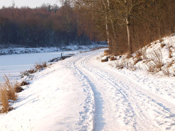 Road passing through snow covered landscape