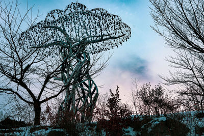 Low angle view of bare tree against sky