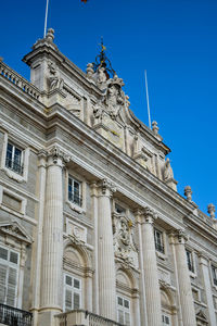 Low angle view of historical building against blue sky