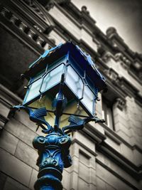 Low angle view of street light against building