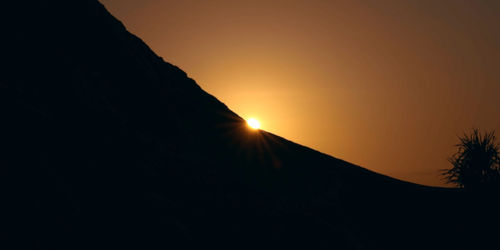 Scenic view of silhouette mountain against sky during sunset