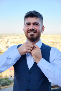 Portrait of man standing against sky