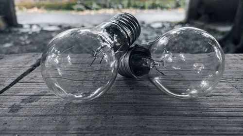 Close-up of light bulb on table