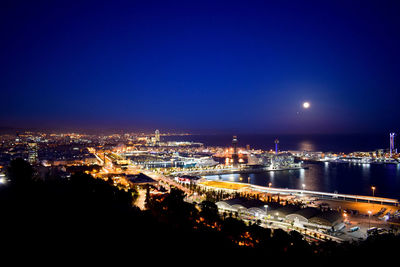 High angle view of illuminated buildings against sky at night