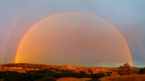 Scenic view of rainbow over mountains