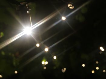 Low angle view of illuminated lights at night