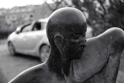 Close-up of statue by cat on street