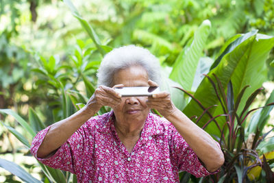 Portrait of young man using mobile phone outdoors