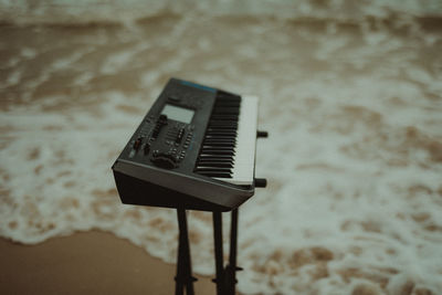 Close-up of piano on beach