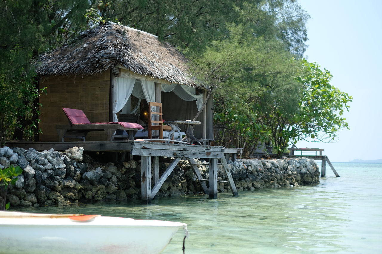 BUILT STRUCTURE AND TREES BY SEA