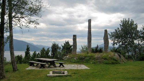 Empty table and benches by the lake