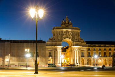 Illuminated city street at night