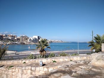 Scenic view of beach against clear blue sky