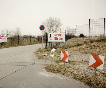 Road sign against sky