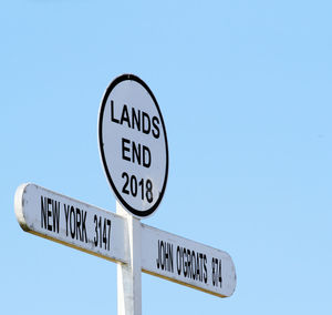 Low angle view of information sign against clear sky