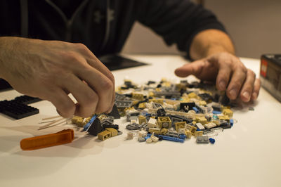 Man with toy blocks on table