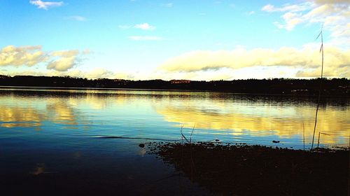 Silhouette floating on water against sky during sunset