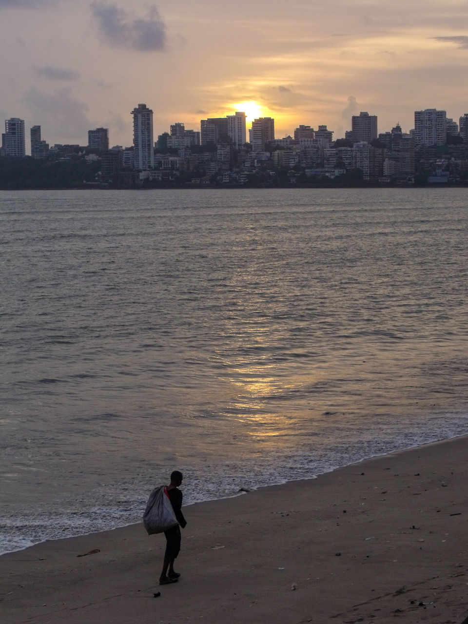 FULL LENGTH OF MAN ON BEACH DURING SUNSET