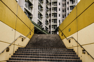 Low angle view of steps against buildings in city