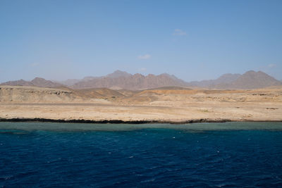 Scenic view of beach against clear sky