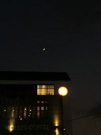 Low angle view of illuminated building against sky at night