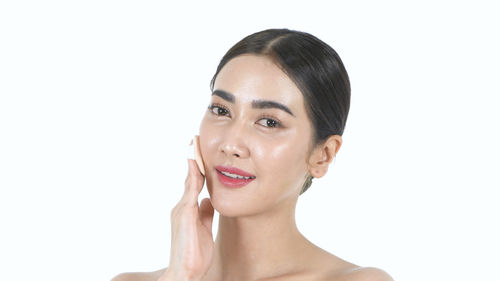 Portrait of a young woman over white background