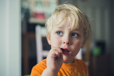 Portrait of boy eating at home