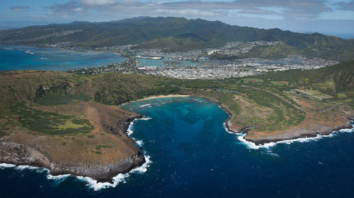 High angle view of sea and mountains against sky