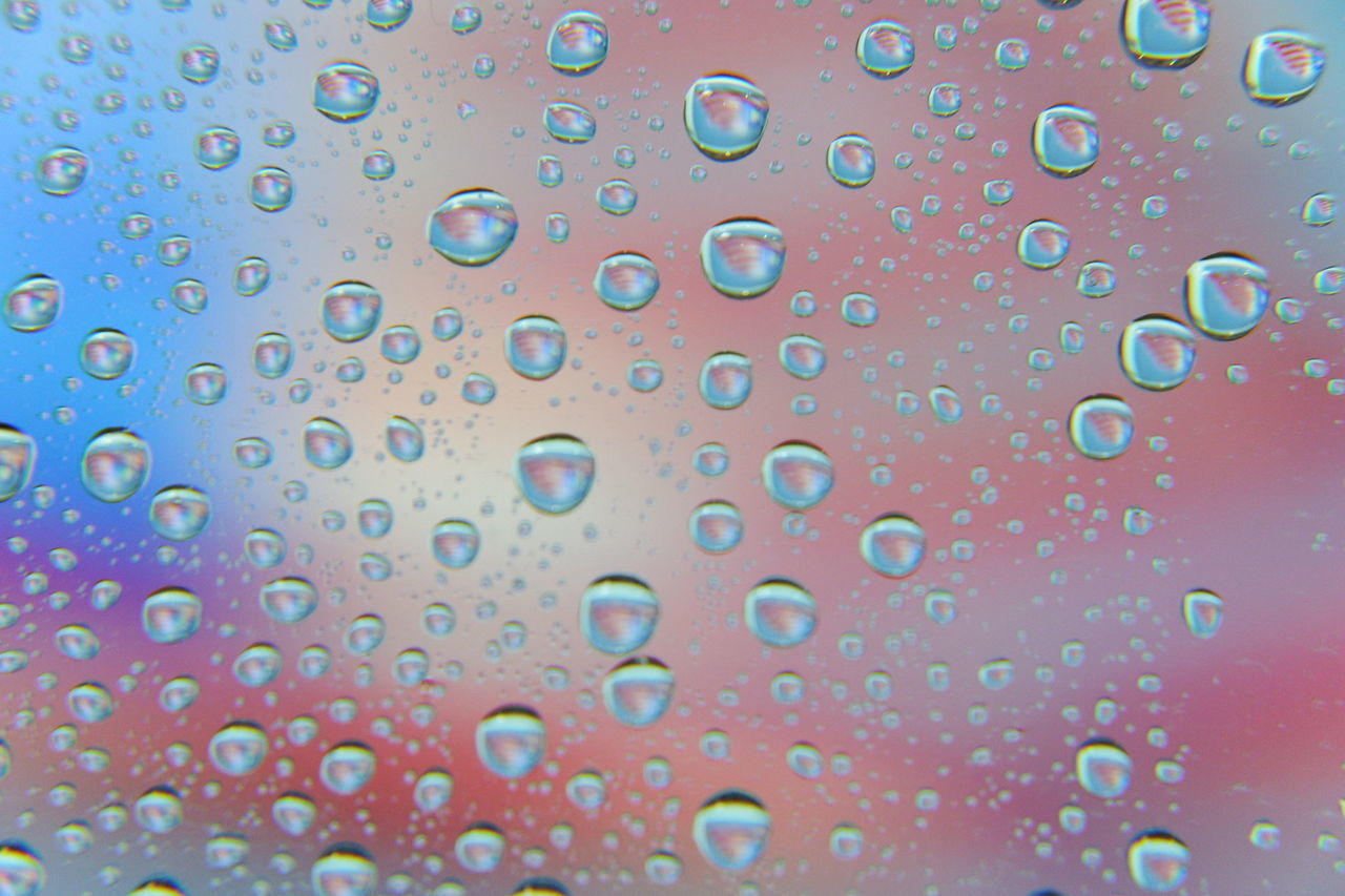 FULL FRAME SHOT OF WATER DROPS ON GLASS