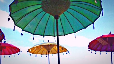 Low angle view of parasol against sky