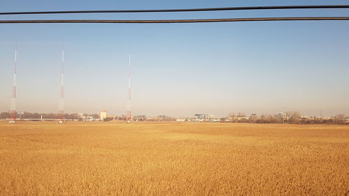 Scenic view of agricultural field against clear sky