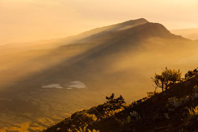 Scenic view of silhouette mountains against sky at sunset