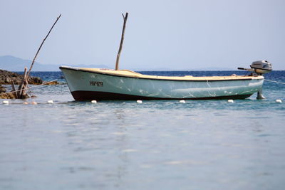 Boat moored at sea against sky