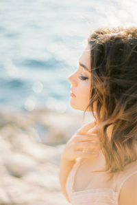 Side view of young woman at beach