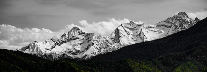 Panoramic view of snowcapped mountains against sky