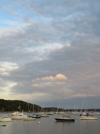 Boats sailing in sea against sky