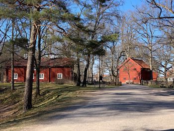 View of old building by trees against sky